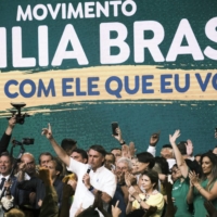 Jair Bolsonaro, Brazil\'s president (center), speaks during a re-election campaign event in Brasilia on March 27. | BLOOMBERG