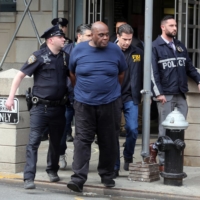 Frank James, the suspect in the Brooklyn subway shooting, exits the Ninth Precinct in Manhattan’s East Village after his arrest on Wednesday. | JEFFERSON SIEGEL / THE NEW YORK TIMES