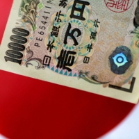 More than three-quarters of Japanese firms say the weak yen is detrimental to their business, a Reuters poll found. | REUTERS