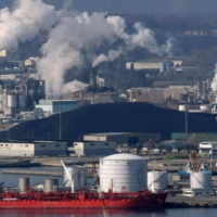 Imported coal is stockpiled after being offloaded at a port in the city of Iwaki, Fukushima Prefecture. | BLOOMBERG