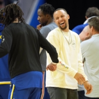 Golden State Warriors guard Stephen Curry (center) laughs on the court during a timeout in a game against the Los Angeles Lakers at Chase Center on April 7. | USA TODAY / VIA REUTERS