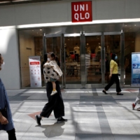 People walk past Fast Retailing\'s Uniqlo store in Beijing in May 2020. | REUTERS