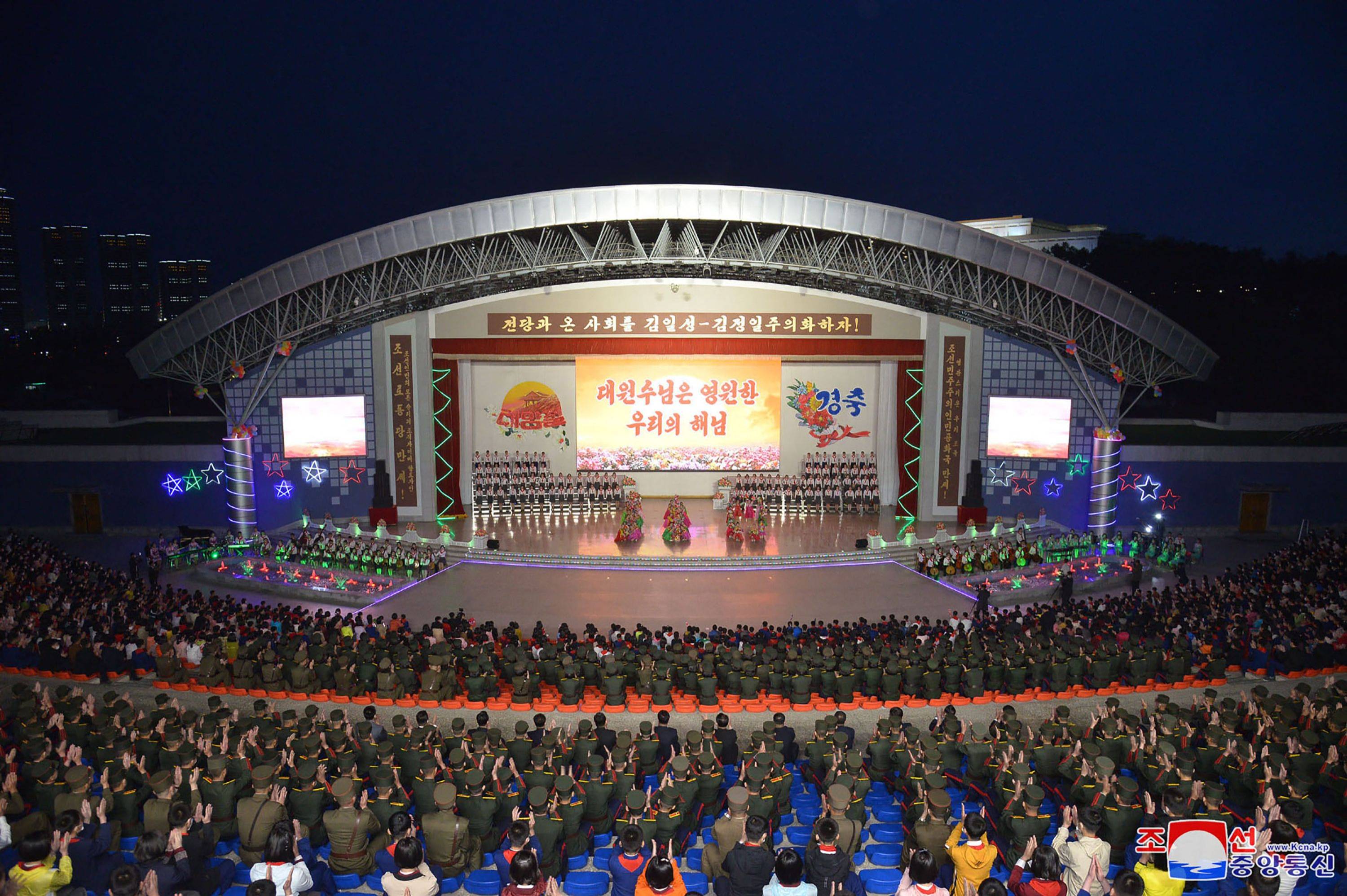 A performance by art circle members celebrating the 110th anniversary of the birth of the late North Korean leader Kim Il Sung at the Pyongyang Youth Park Open Air Theater in Pyongyang on Wednesday | KCNA / KNS / VIA AFP-Jiji