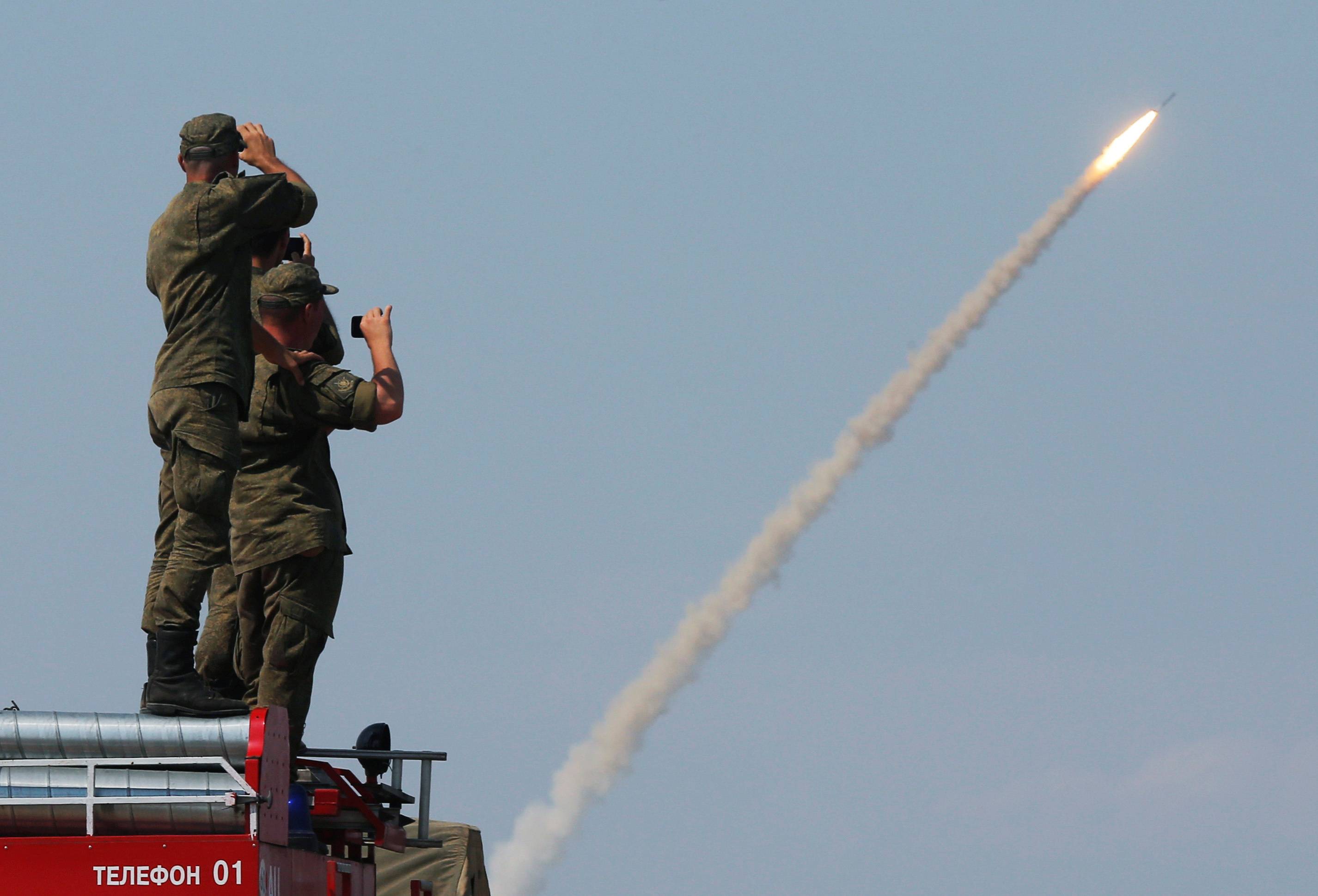 Russian servicemen watch the launch of the S-300 air defence system missile launch during the International Army Games 2016 at the Ashuluk military polygon outside Astrakhan, Russia. | REUTERS