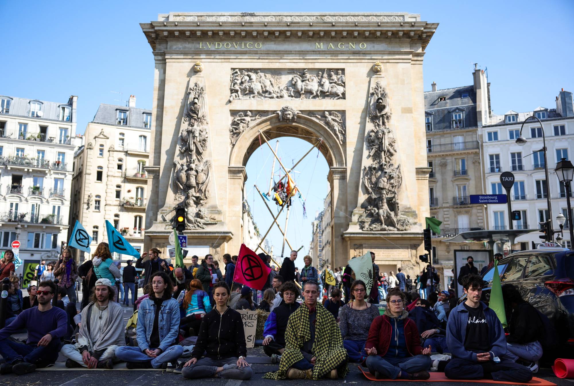 Activists demand ecological and social justice ahead of the second round of the 2022 French presidential election in Paris on Saturday.  | REUTERS
