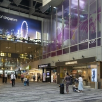 Travelers walk through the transit area at Changi Airport in Singapore.  | BLOOMBERG
