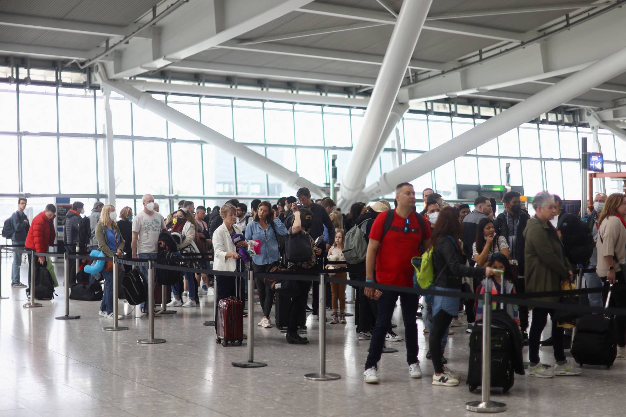 Lines formed at Heathrow Airport’s Terminal 5 in advance of the Easter holiday as the number of travelers surged. | HANNAH MCKAY / REUTERS