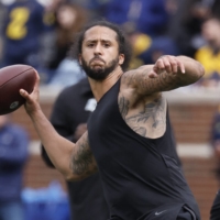 Colin Kaepernick passes during halftime at the Michigan Spring Game in Ann Arbor, Michigan, on April 2. | USA TODAY / VIA REUTERS