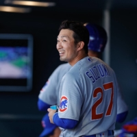 Cubs outfielder Seiya Suzuki returns to the dugout after hitting a solo home run against the Rockies in Denver on Sunday. | USA TODAY / VIA REUTERS