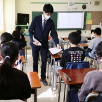 Sixth graders take a national achievement test at an elementary school in Tokyo on Tuesday. | POOL / VIA KYODO