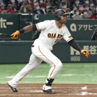 Giants outfielder Gregory Polanco hits a go-ahead two-run double against the Carps at the Tokyo Dome on Wednesday. | KYODO
