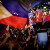 Philippine presidential candidate Ferdinand \"Bongbong\" Marcos Jr., son of late dictator Ferdinand Marcos, gestures with a victory sign during a campaign rally in Lipa, Batangas province, the Philippines, on Wednesday. | REUTERS