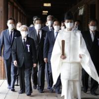A cross-party group of lawmakers, led by its chief Hidehisa Otsuji (second from left), visits Yasukuni Shrine in Tokyo on Friday. | KYODO