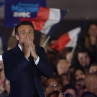French President Emmanuel Macron celebrates his re-election in at the Champ de Mars in Paris on Sunday. | AFP-JIJI