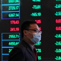 A man walks through the Shanghai Stock Exchange building in Shanghai\'s Pudong financial district in February, 2020. | REUTERS
