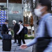 Pedestrians in Tokyo on Monday. Japan\'s jobless rate fell to 2.6% in March, hitting the lowest rate since April 2020. | BLOOMBERG