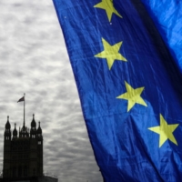 Anti-Brexit campaigners wave the European Union (EU) flag outside the Houses of Parliament in London on Dec. 9, 2020.  | BLOOMBERG