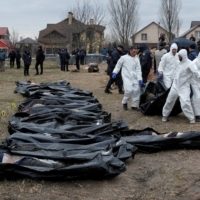 Forensic technicians exhume the bodies of civilians who Ukrainian officials say were killed during Russia\'s invasion and then buried in a mass grave, in the town of Bucha, outside Kyiv, on April 8. | REUTERS 