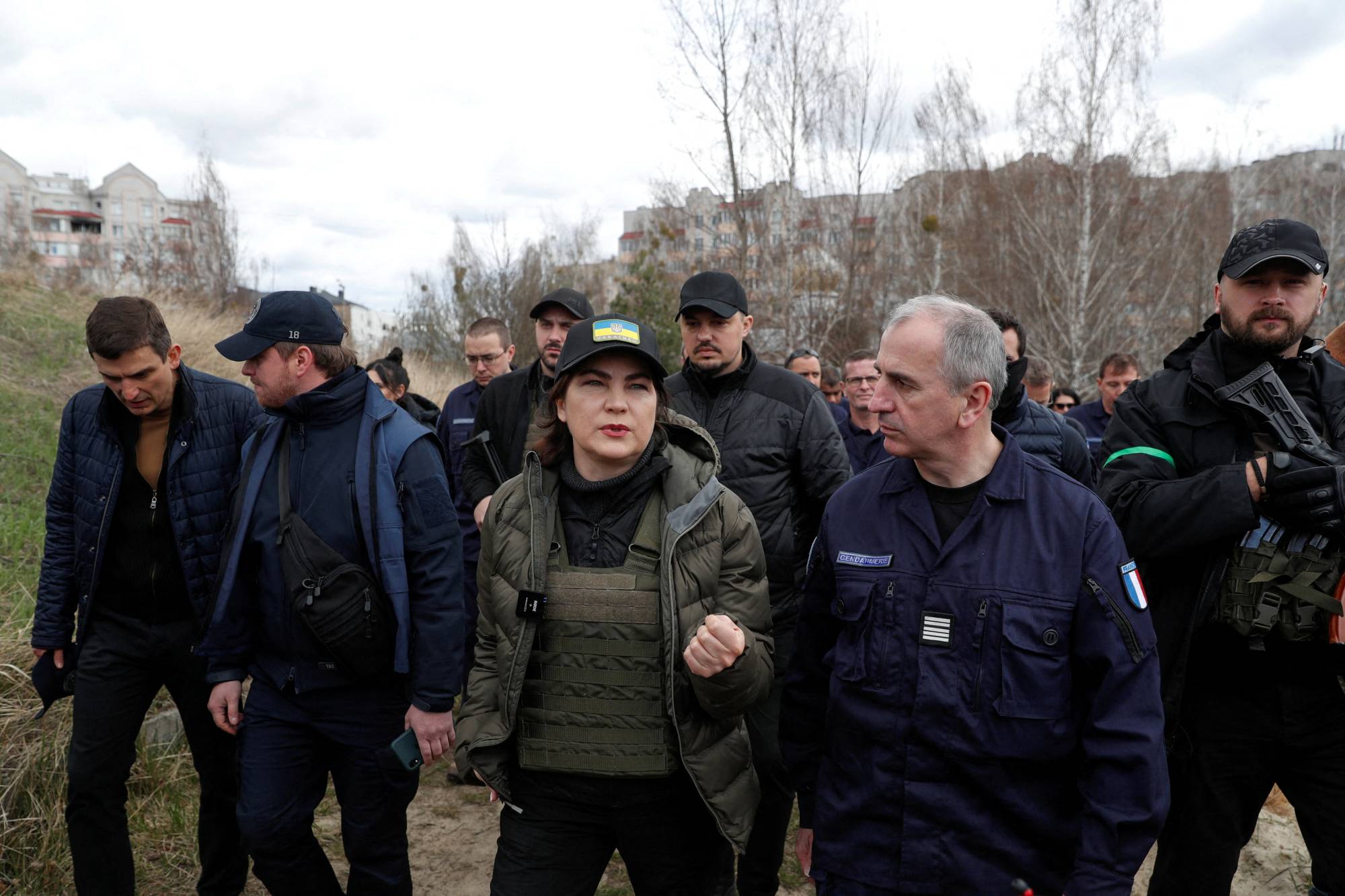 Ukrainian Prosecutor General Iryna Venediktova (center) speaks to a representative of French forensics investigators in Bucha on April 12. | Reuters 