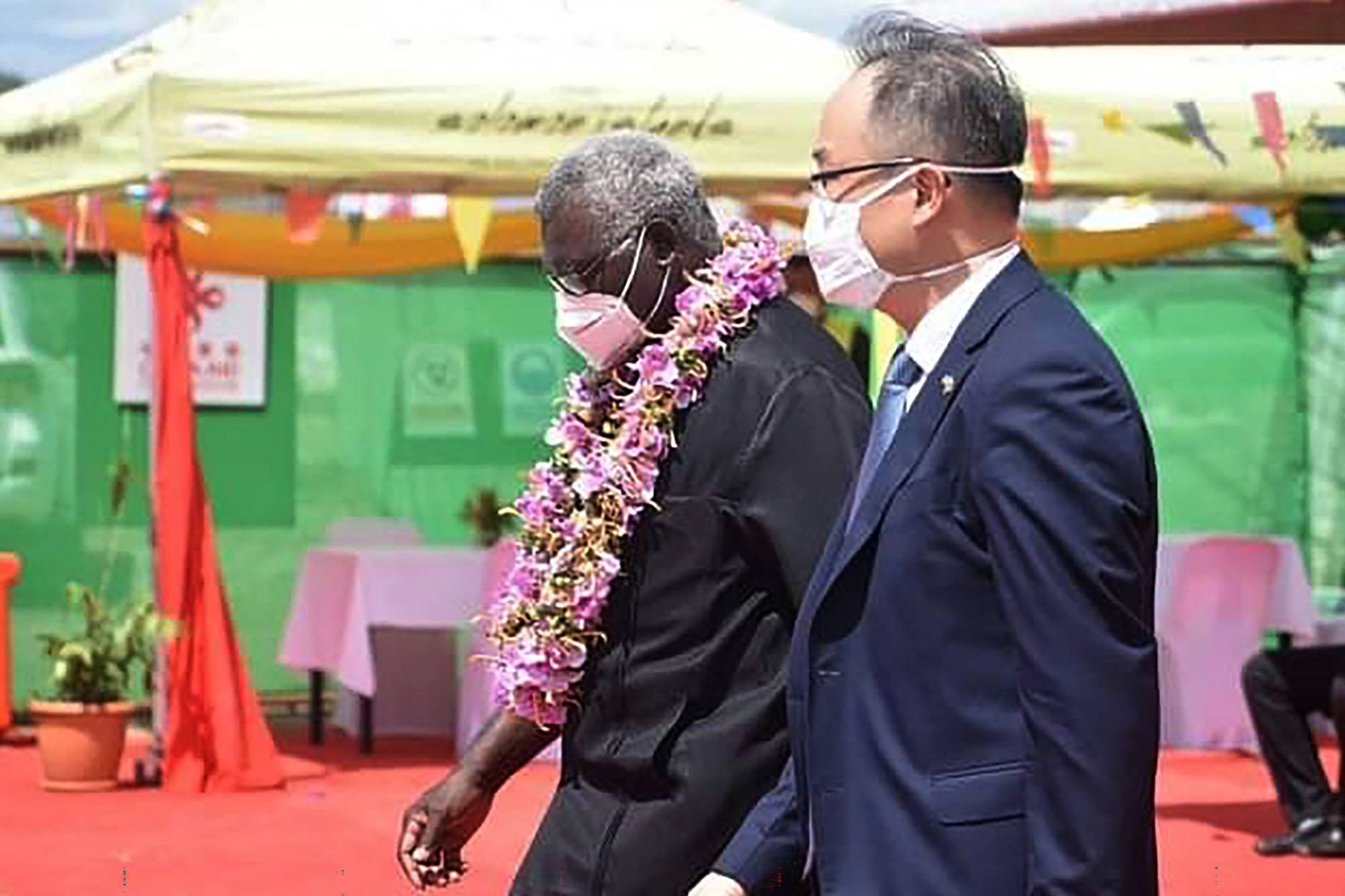 Chinese Ambassador to the Solomon Islands Li Ming (right) and Solomon Islands Prime Minister Manasseh Sogavare attend the opening ceremony of a China-funded national stadium complex in Honiara, Solomon Islands. | AFP-Jiji