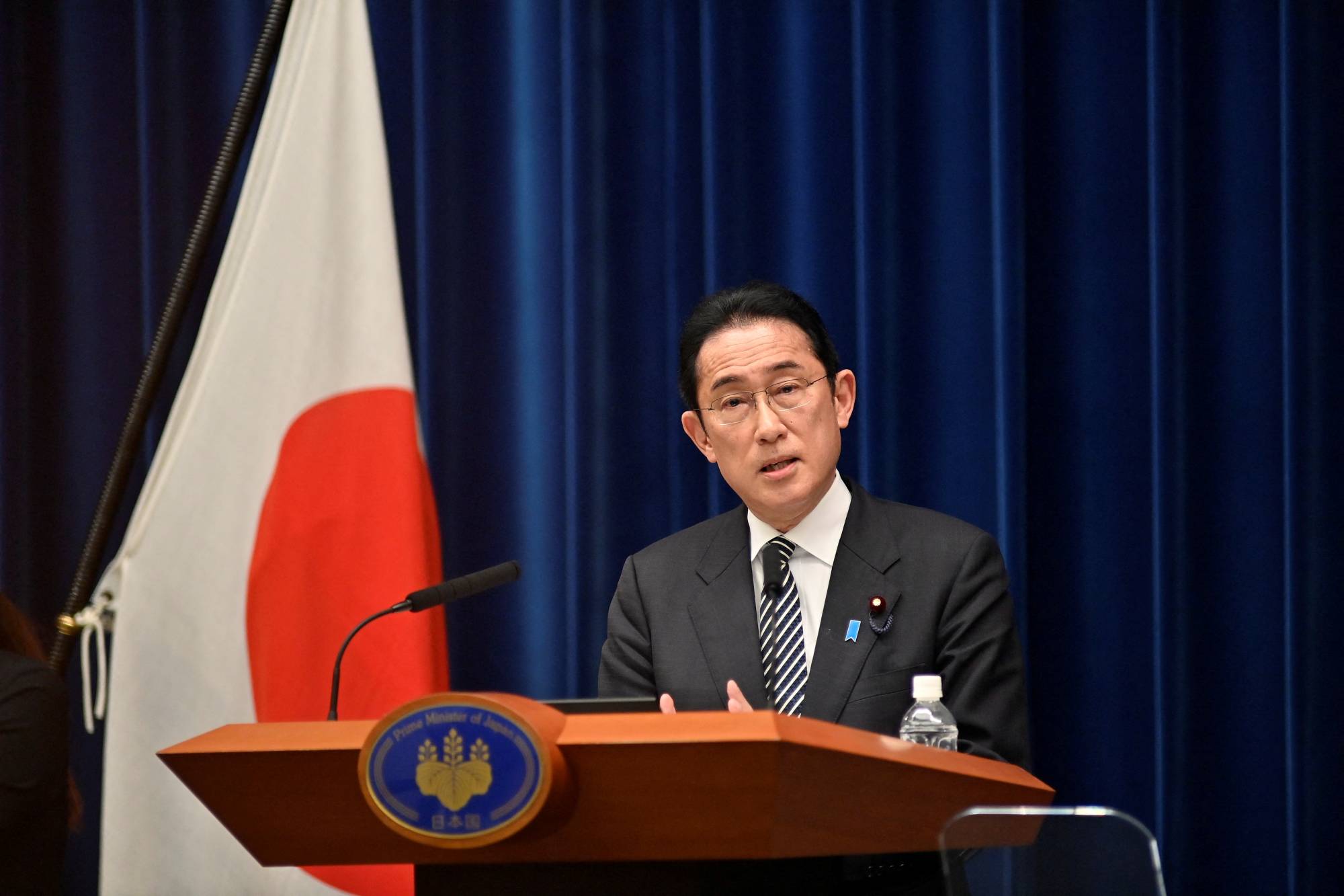 Prime Minister Fumio Kishida speaks during a news conference in Tokyo on Tuesday. | Pool / via REUTERS