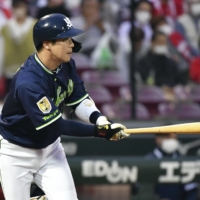 Swallows second baseman Tetsuto Yamada hits a double against the Carp at Mazda Stadium in Hiroshima on Wednesday. | KYODO