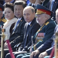 Russian President Vladimir Putin and Chinese leader Xi Jinping attend a Victory Day parade in Red Square in Moscow in May 2015.  | RIA NOVOSTI / VIA REUTERS
