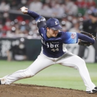Lions reliever Kaito Yoza pitches against the Hawks in Fukuoka on Thursday. | KYODO