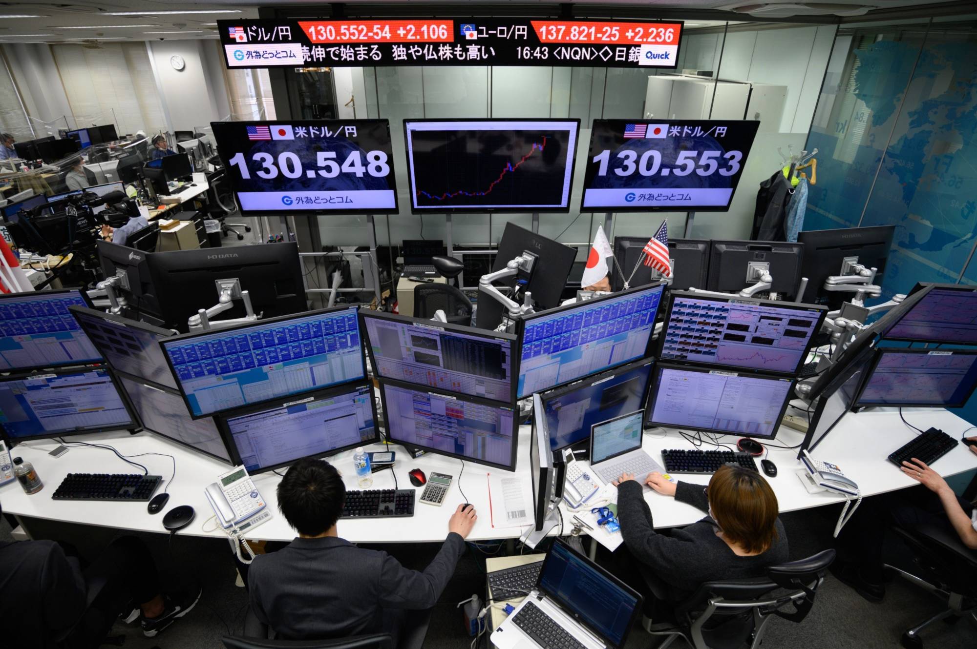 The rate of the yen against the U.S. dollar is displayed in the trading room at foreign exchange brokerage Gaitame.Com Co. in Tokyo on Thursday. The Bank of Japan sparked a sharp slide in the yen and a currency warning from an official after doubling down on its promise to defend a rock-bottom yield target that leaves it as a dovish outlier among major central banks tightening policy. | BLOOMBERG 