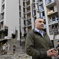 Kyiv Mayor Vitali Klitschko stands in front of a damaged building Friday following Russian strikes on the city.  | AFP-JIJI