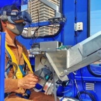The operator controls the robot from the truck’s cockpit, monitoring the operation through goggles that carry a video feed from a camera attached to the robot\'s upper half.  | JR WEST
