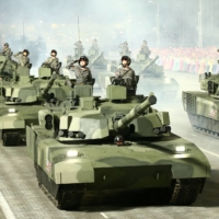 Troops in armored vehicles participate in a military parade in Pyongyang in this undated photo released on April 26. | KCNA / VIA REUTERS 