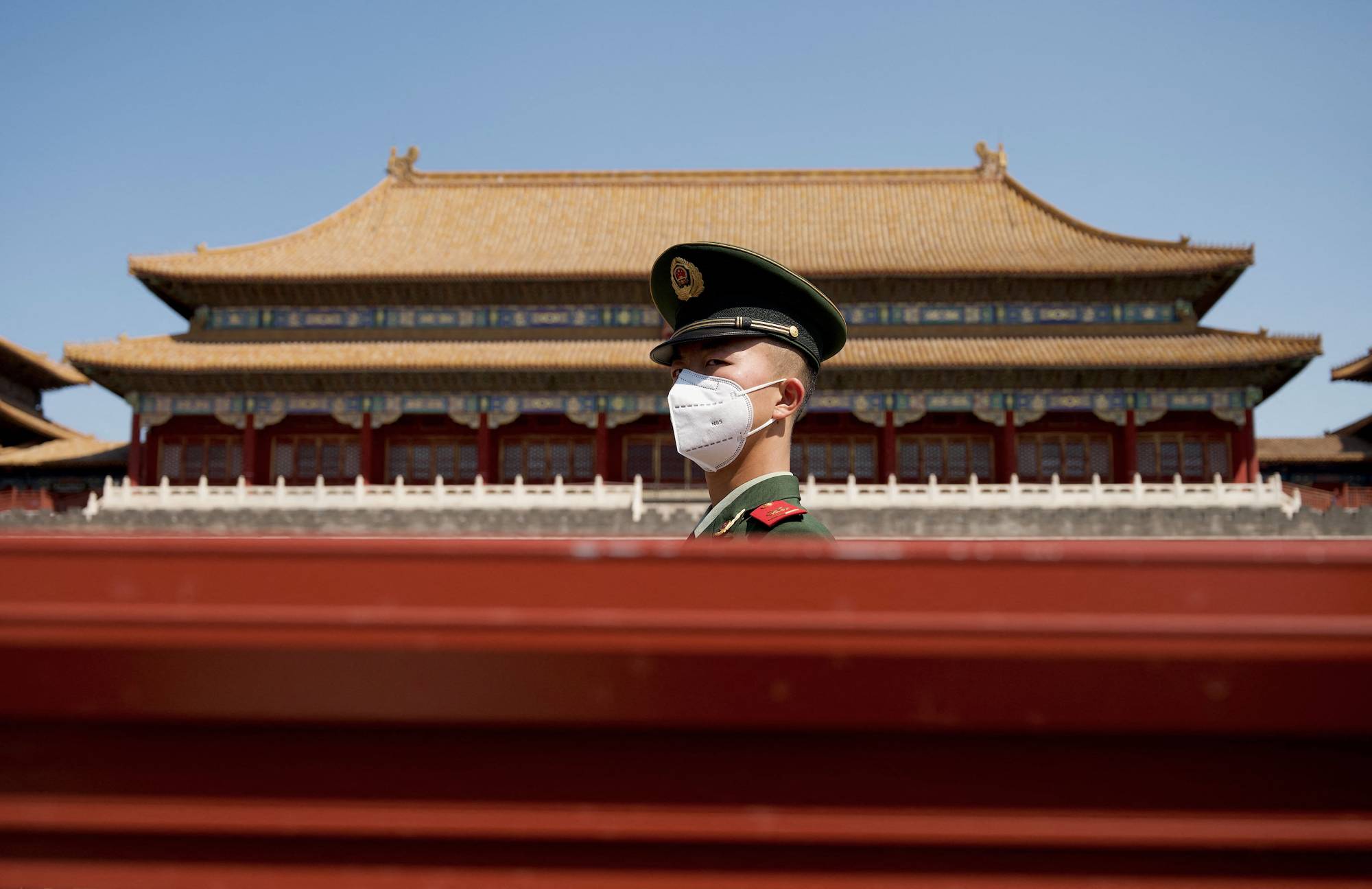 A security guard stands near the entrance of the Forbidden City during the first day of the Labor Day holidays in Beijing on Monday. | AFP-JIJI