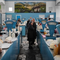 People buy dairy products at the central market in Chisinau on Friday.  | AFP-JIJI