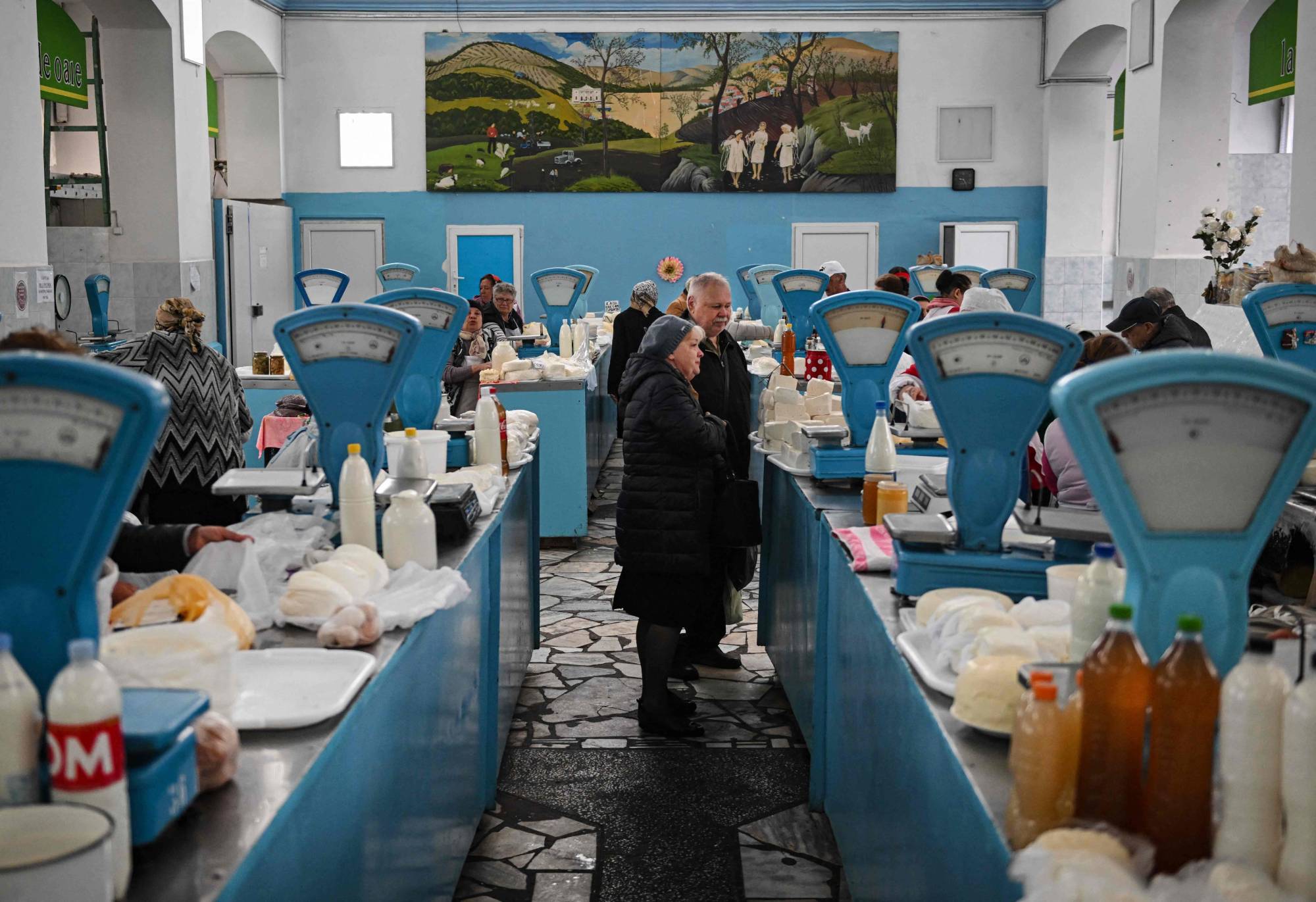 People buy dairy products at the central market in Chisinau on Friday. | AFP-JIJI