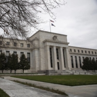 The Marriner S. Eccles Federal Reserve building in Washington on April 10. Federal Reserve officials laid out a long-awaited plan to shrink their balance sheet by more than $1 trillion a year while raising interest rates \"expeditiously\" to counter the hottest inflation in four decades. | BLOOMBERG