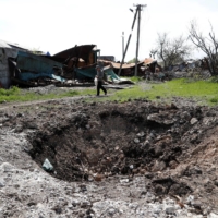 A shell crater in the course of the Ukraine-Russia conflict in the southern port city of Mariupol, Ukraine, on Tuesday  | REUTERS