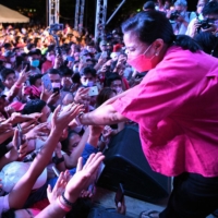 Philippine Vice President and opposition presidential candidate Leni Robredo (right) greeting supporters during a campaign rally ahead of the May presidential election in Borongan, Eastern Samar province on March 29.  | AFP-JIJI