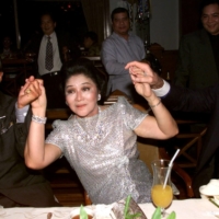 Actor George Hamilton (left) and lawyer James Linn hold hands with former Philippine first lady Imelda Marcos as she celebrates her 70th birthday on July 1, 1999. | REUTERS 