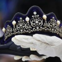 A Presidential Commission on Good Government official displays an item from the confiscated jewelry collection of former Philippine first lady Imelda Marcos. | REUTERS 