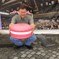 Writer Bruce Henderson of sumo blog Tachiai poses with a giant macaron given as part of the France-Japan Friendship Cup to basho winners in 2016. | COURTESY OF BRUCE HENDERSON
