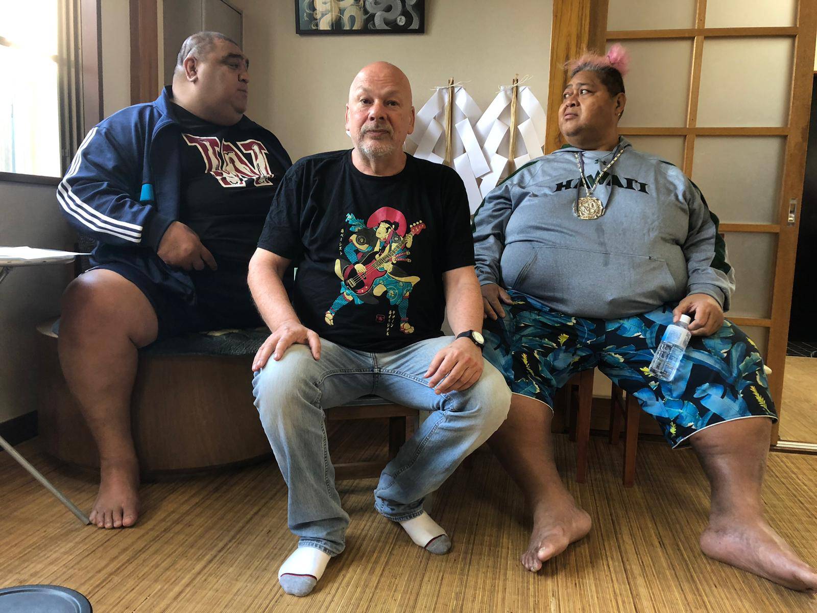 Israeli musican and sumo content creator Moti Dichne (center) poses with former yokozuna Musashimaru (left) and former ozeki Konishiki at Musashigawa stable in May 2019. | Courtesy of Moti Dichne