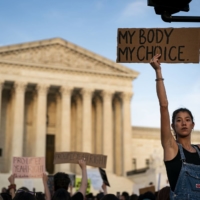 Abortion rights demonstrators during a protest outside the U.S. Supreme Court in Washington on Tuesday | BLOOMBERG
