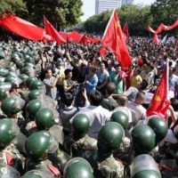 Riot police block demonstrators outside the Japanese Embassy during a protest in Beijing in September 2012, at a time of growing tensions over the Senkaku Islands.  | REUTERS