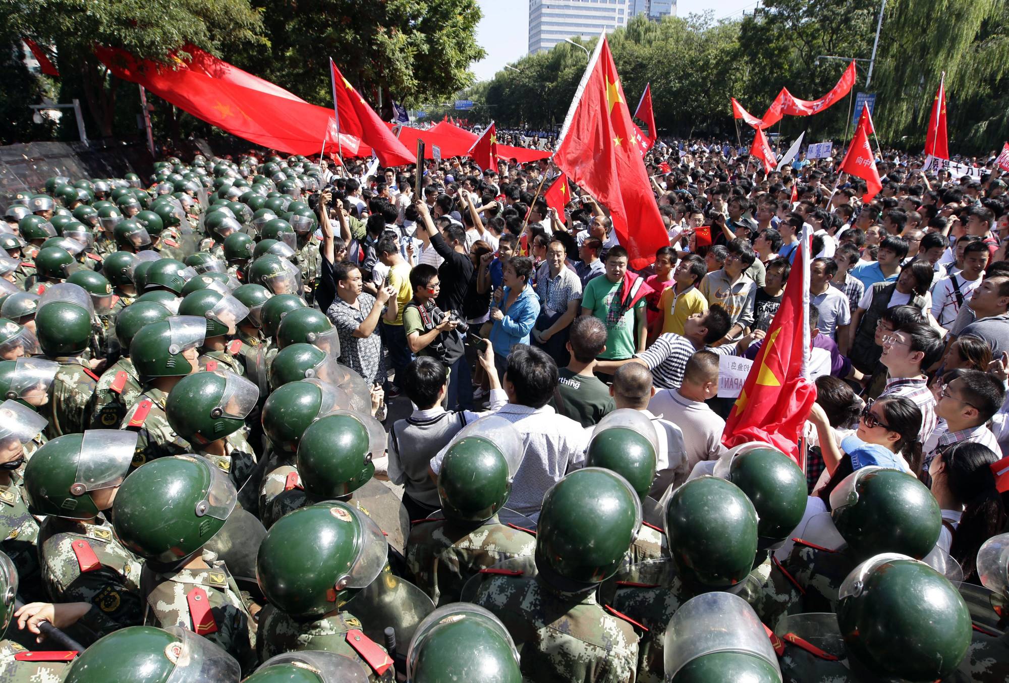 Riot police block demonstrators outside the Japanese Embassy during a protest in Beijing in September 2012, at a time of growing tensions over the Senkaku Islands. | Reuters