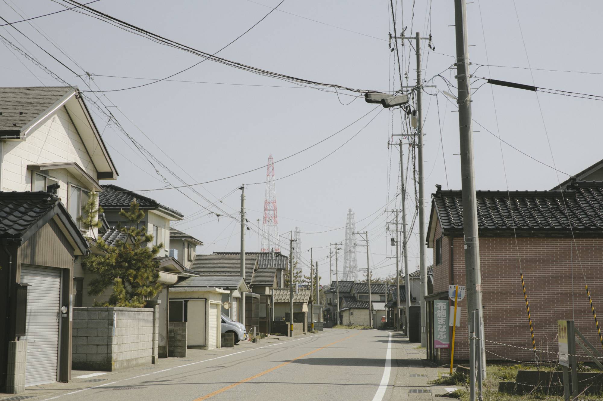 An idled nuclear power plant, including its large steel towers, looms over nearby communities in Kashiwazaki, Niigata Prefecture.  | HARUKA SAKAGUCHI / THE NEW YORK TIMES