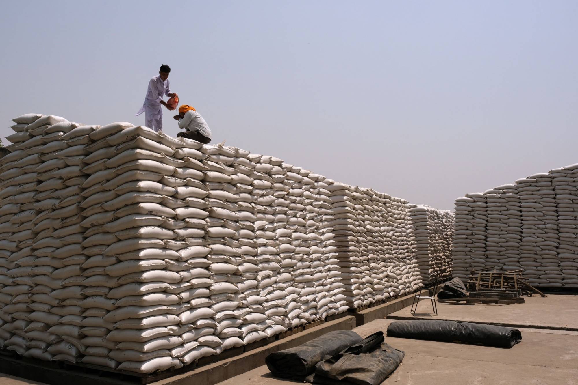 Wheat sacks at a Punjab Grains Procurement Corp. facility in the Ludhiana district of Punjab, India, on May 1. A | Bloomberg
