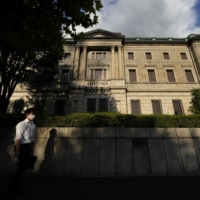 Many board members of the Bank of Japan said it is necessary to maintain monetary easing measures to support the economy\'s recovery from the pandemic, according to the minutes of their March policy meeting. | BLOOMBERG