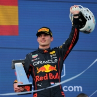 Red Bull\'s Max Verstappen celebrates with the winner\'s trophy and a Dolphins helmet after winning the Miami Grand Prix on Sunday. | REUTERS