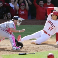 The Angels\' Shohei Ohtani slides home to score the winning run against the Nationals in Anaheim, California, on Sunday. | KYODO